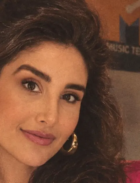 Dra. Laís Machado sorrindo, de blazer rosa